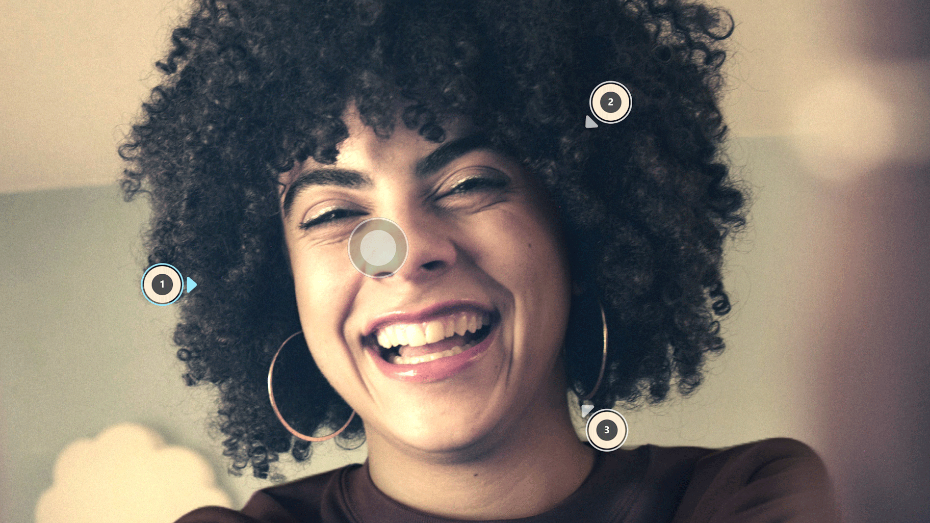A woman smiling with several dots on the photo that show how the Relight feature on the Windows Photo app works.