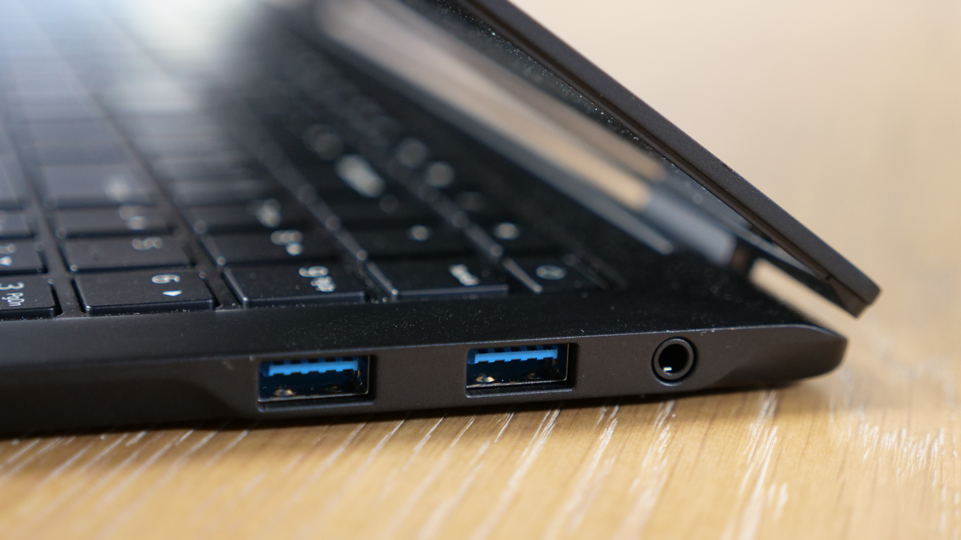 LG Gram Pro 16 2-in-1 (16T90SP) on a wooden table, showing ports on the right side.