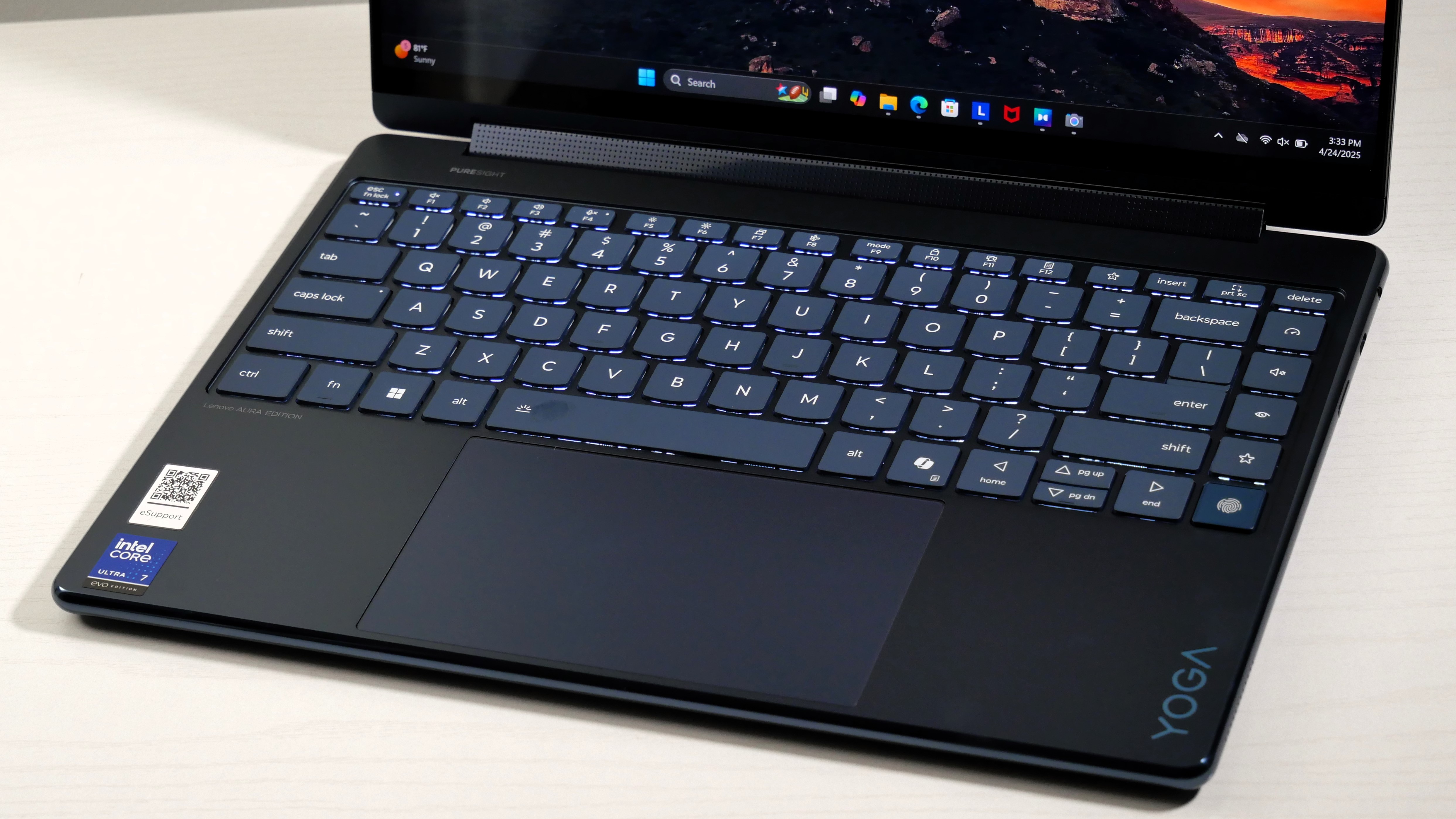 Lenovo Yoga 9i 2-in-1 Aura Edition open on a desk, highlighting the keyboard.