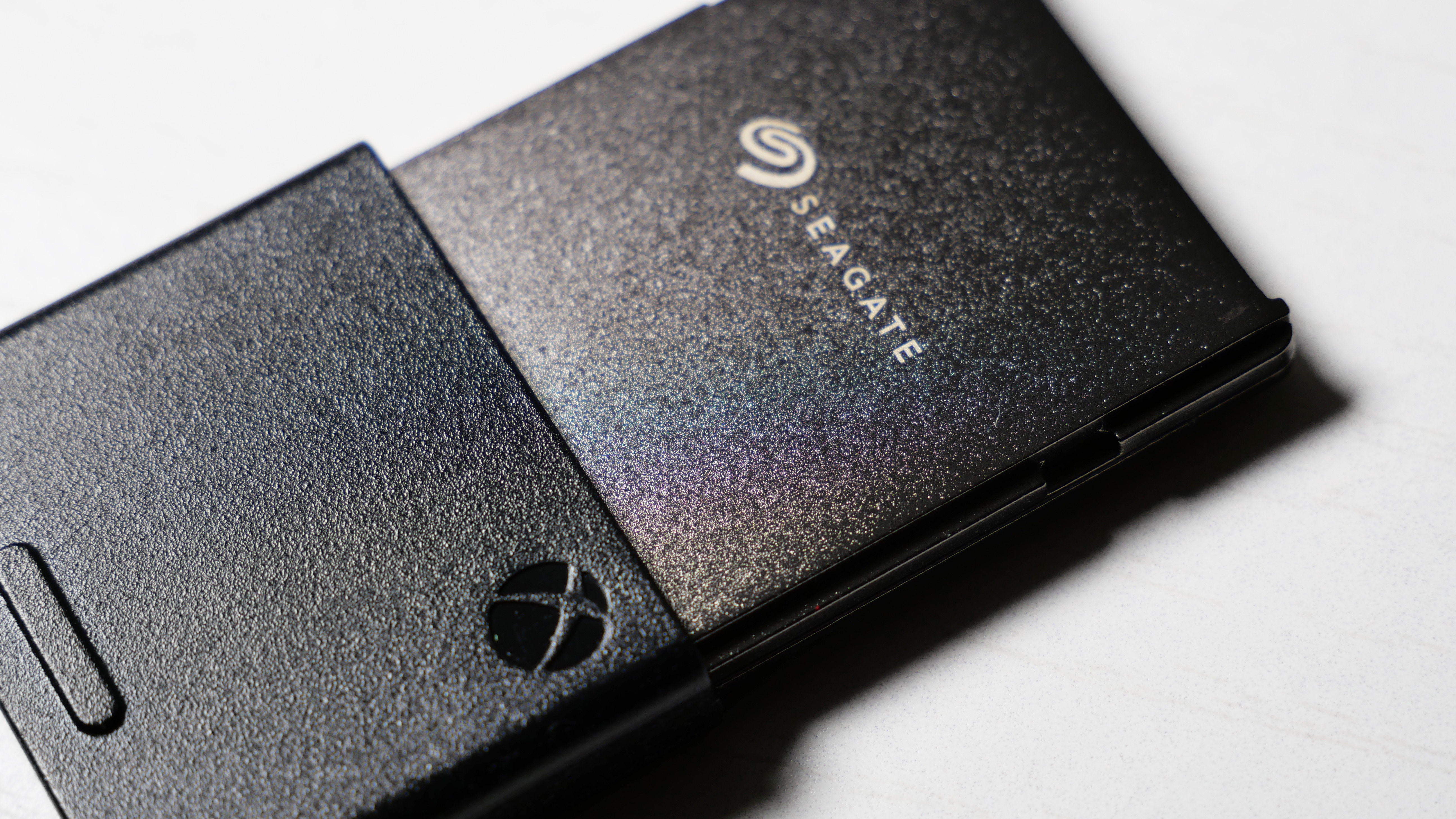 4TB Seagate Storage Expansion Card on a white desk, highlighting its light-and-thin design.