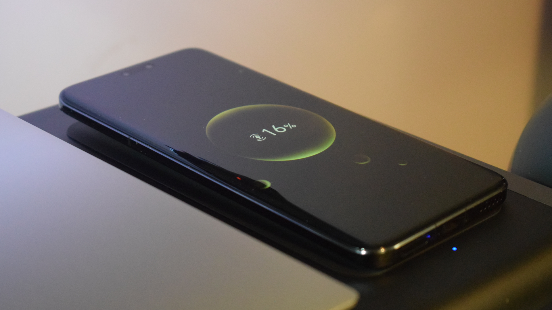 Photo of an Honor Magic5 Pro smartphone wirelessly charging on the Anker 675 USB-C Docking Station's built-in wireless charge pad.