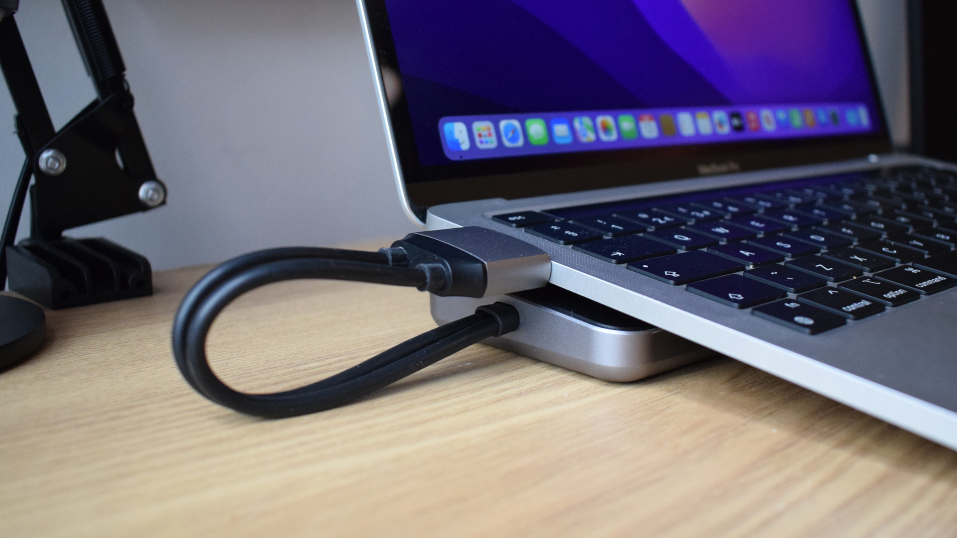 An image showing a MacBook Air on top of the Satechi Dual Dock Stand connecting to its two left-facing Thunderbolt ports.