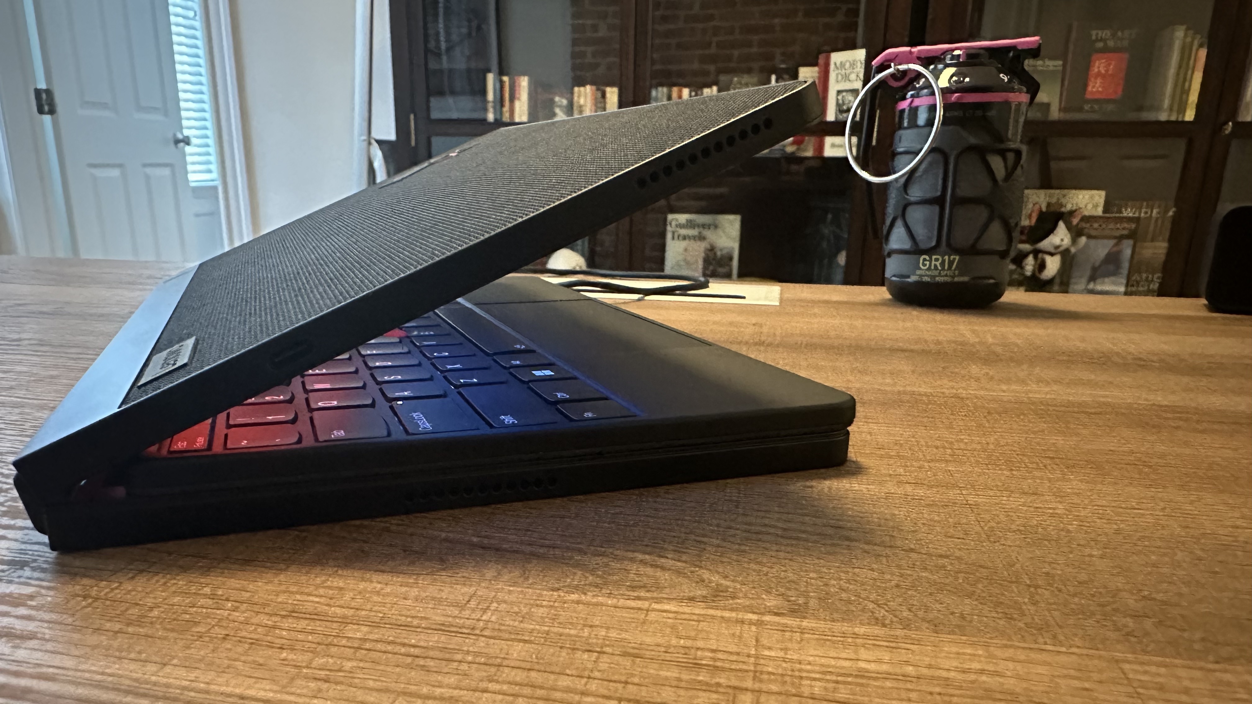 Lenovo ThinkPad X1 Fold 16 Gen 1 side view with the laptop nearly closed