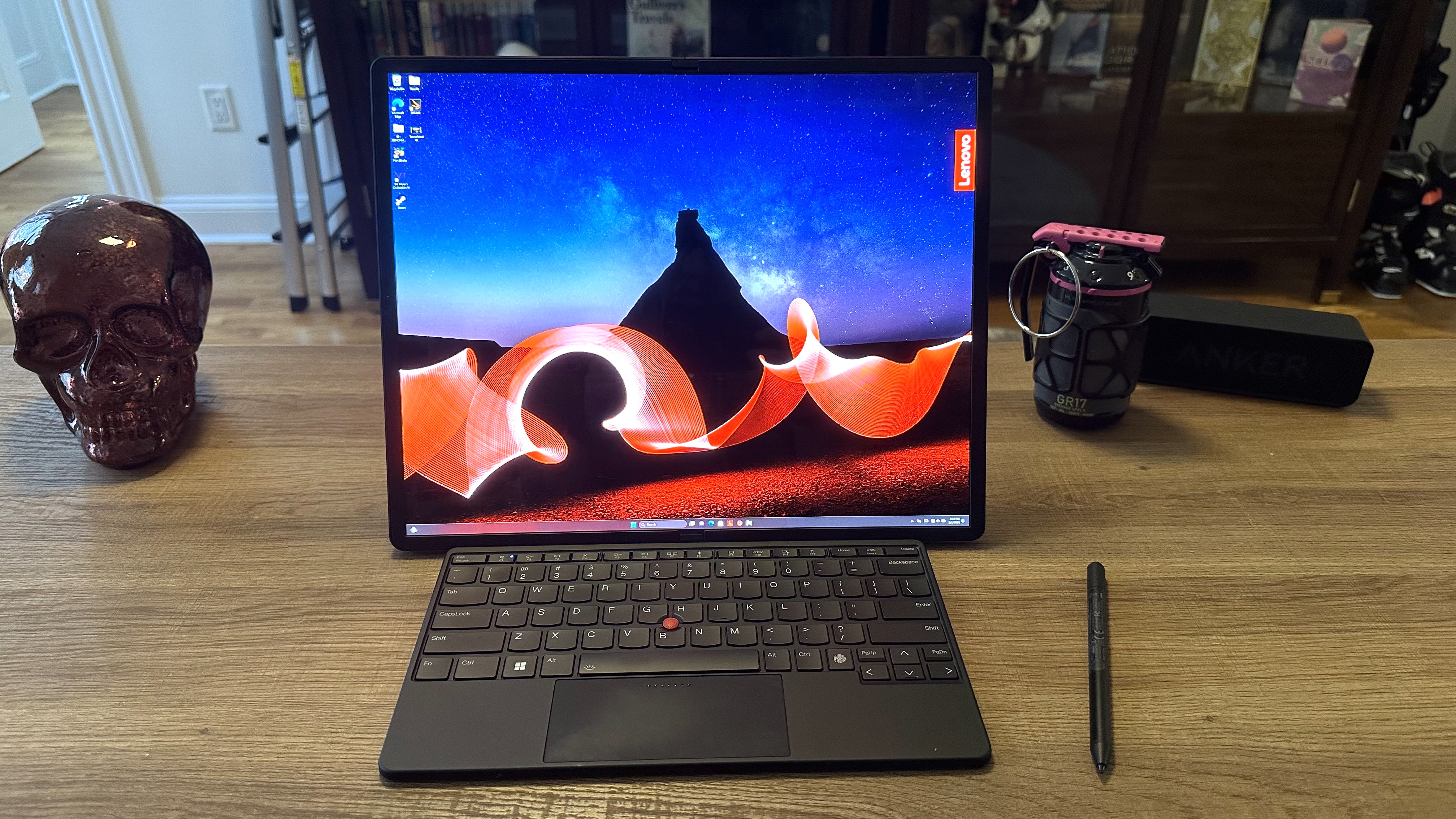 The Lenovo ThinkPad X1 Fold 16 open and propped up in horizontal mode, with the physical keyboard set up in front of the laptop.