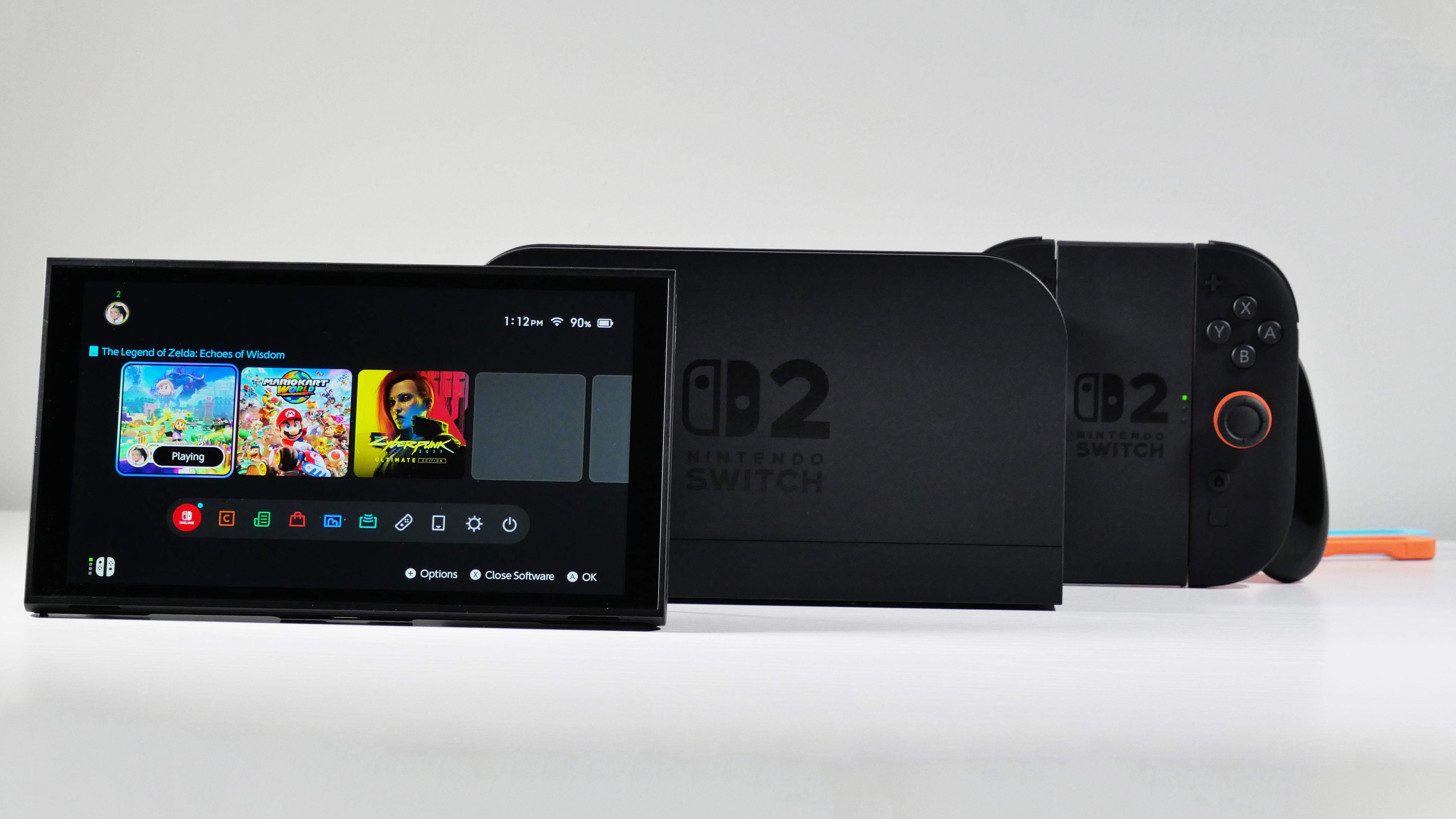 Nintendo Switch 2, Dock, Joy-Con 2 Grip, and Straps displayed on a white desk.