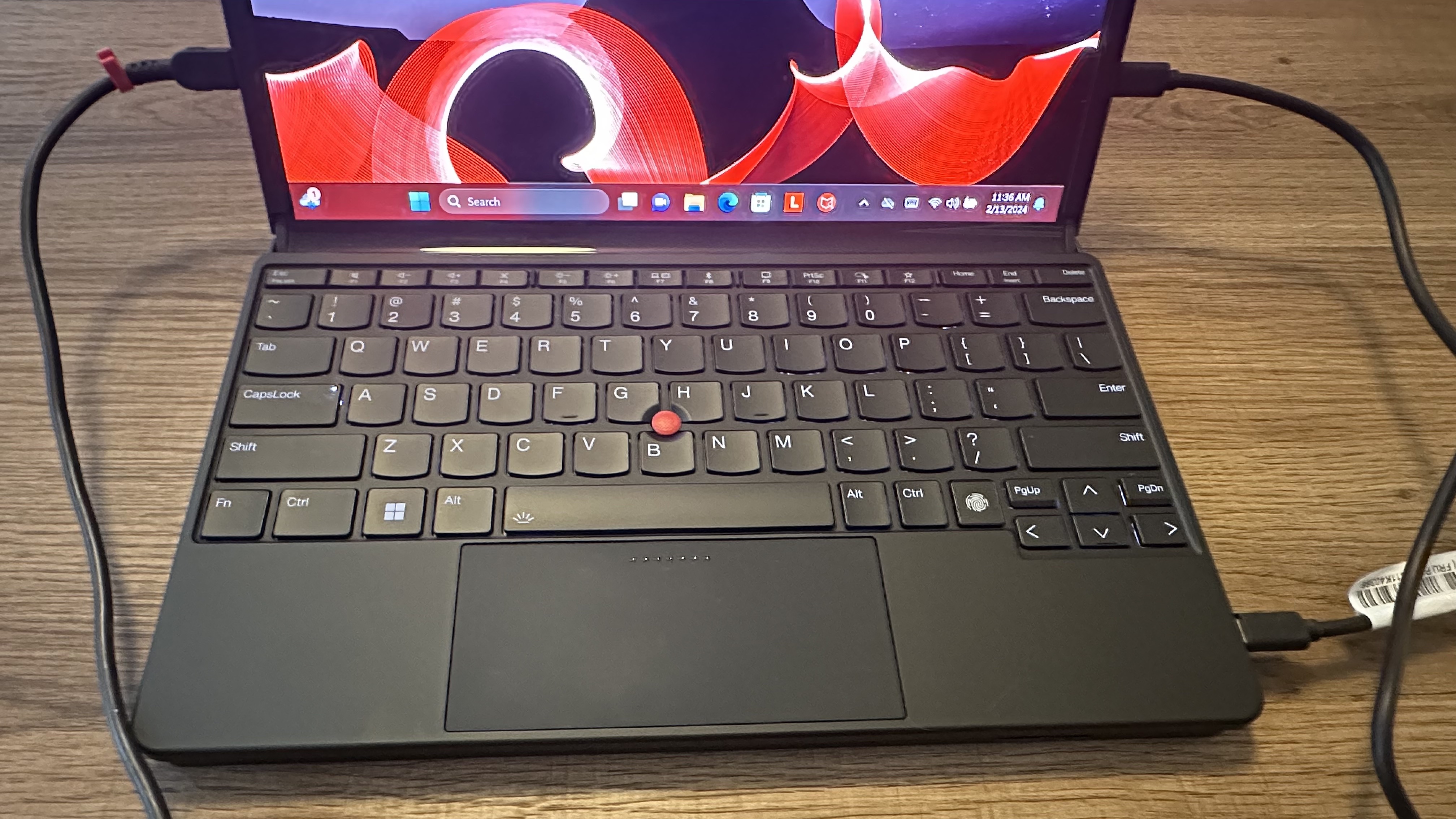 An overhead view of the Lenovo ThinkPad X1 Fold 16 Gen 1 physical keyboard with a red TrackPoint dot.