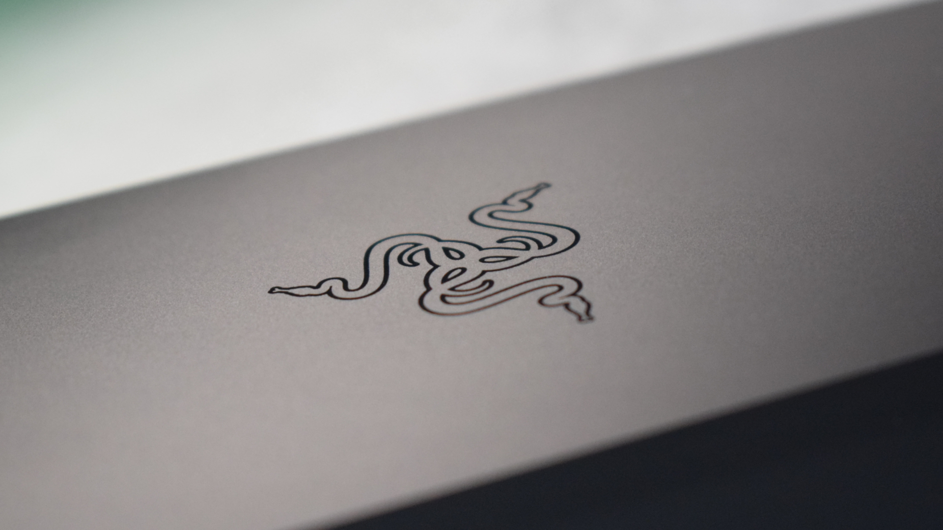 Macro photo of the Razer emblem on top of the Razer Thunderbolt 4 Dock Chroma