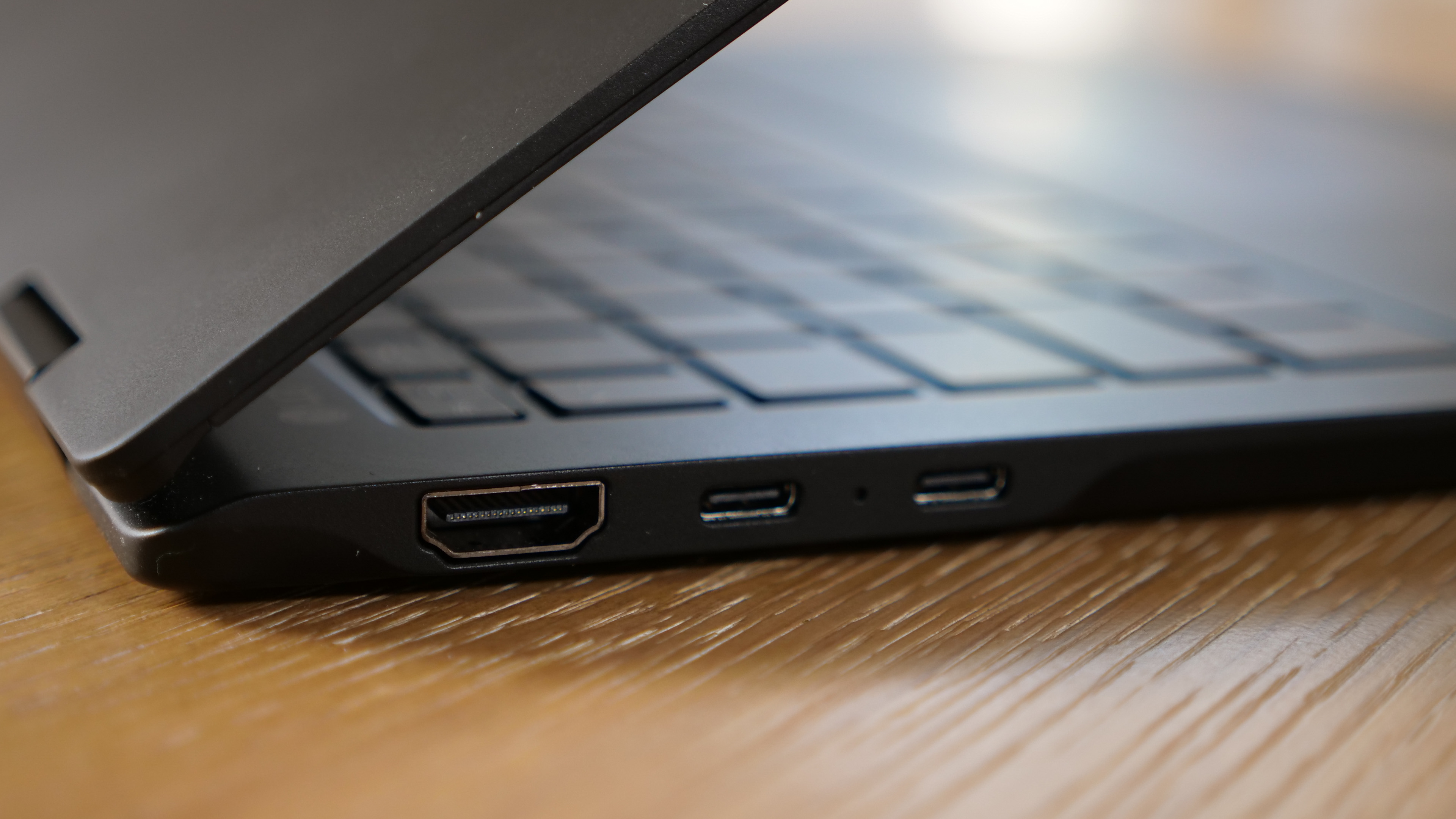 LG Gram Pro 16 2-in-1 (16T90SP) on a wooden table, showing ports on the left side.