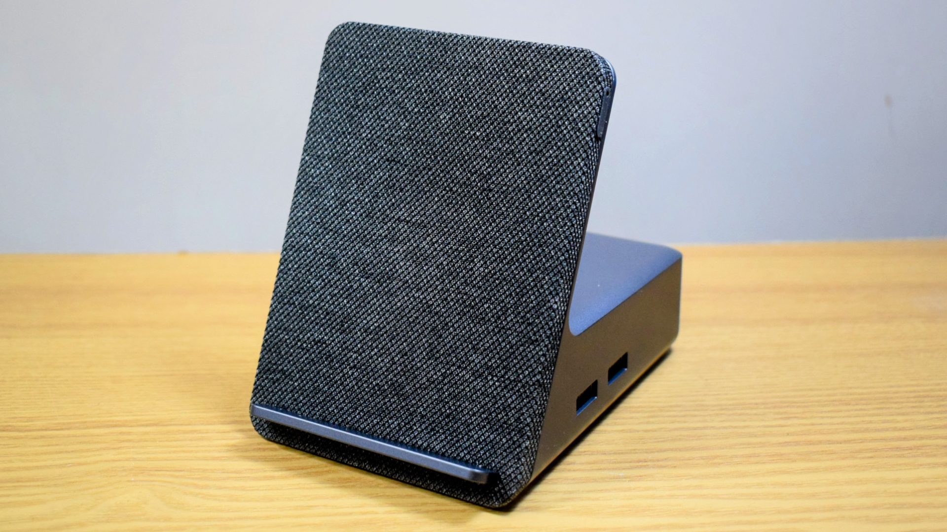 Photo of the Dell Dual Charge Dock with QI wireless charging docking station on a wooden surface.