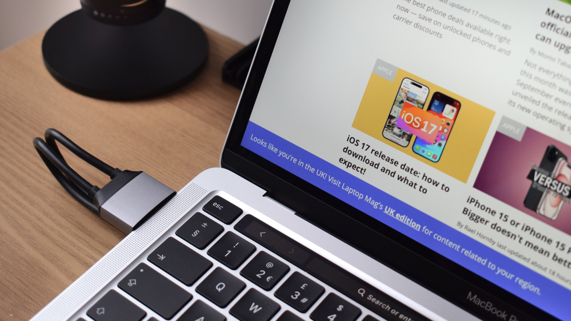 A close-up image showing a MacBook Air on top of the Satechi Dual Dock Stand connecting to its two left-facing Thunderbolt ports.