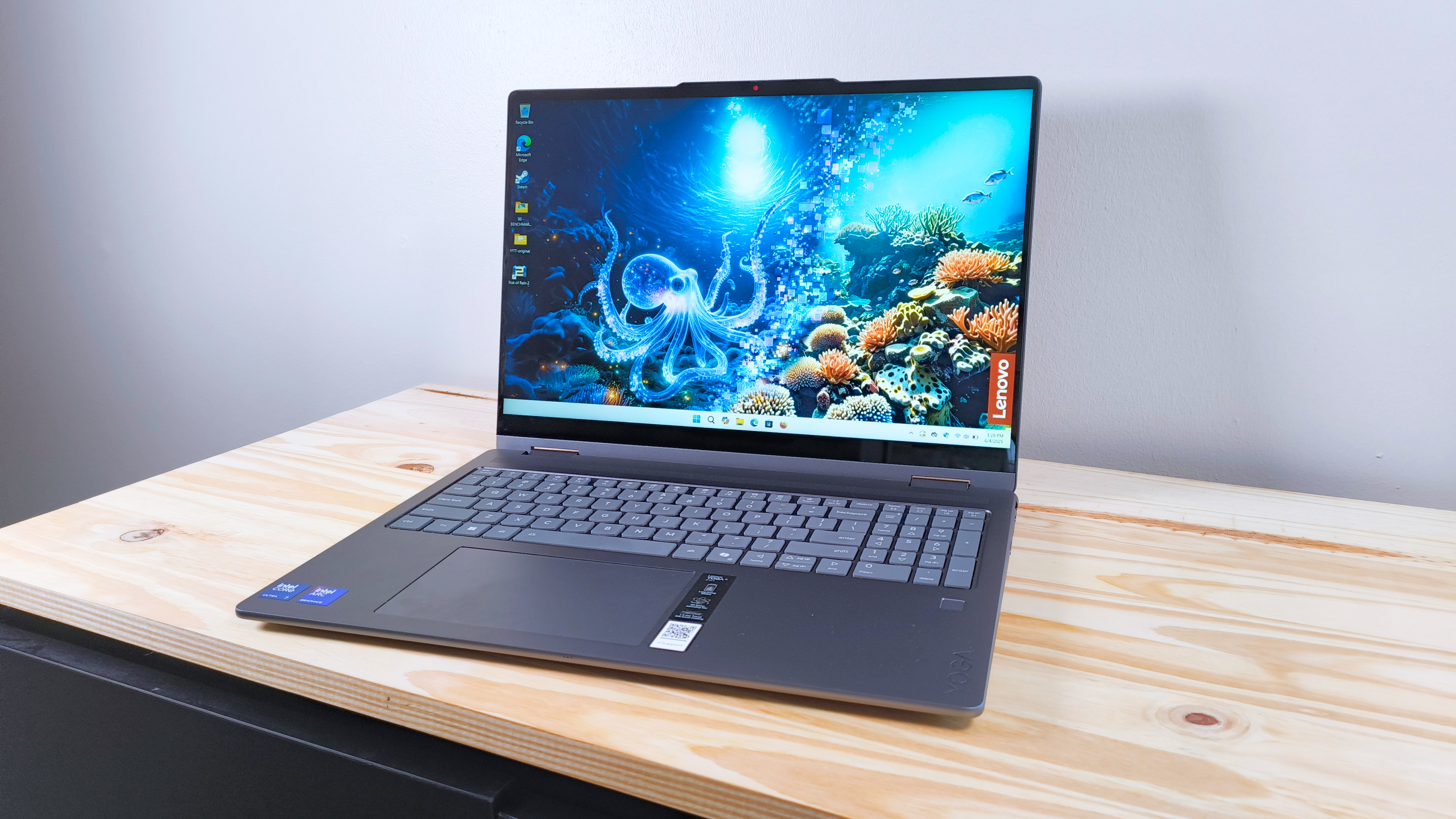 The Lenovo Yoga 7i 2-in-1 16 on a wood table