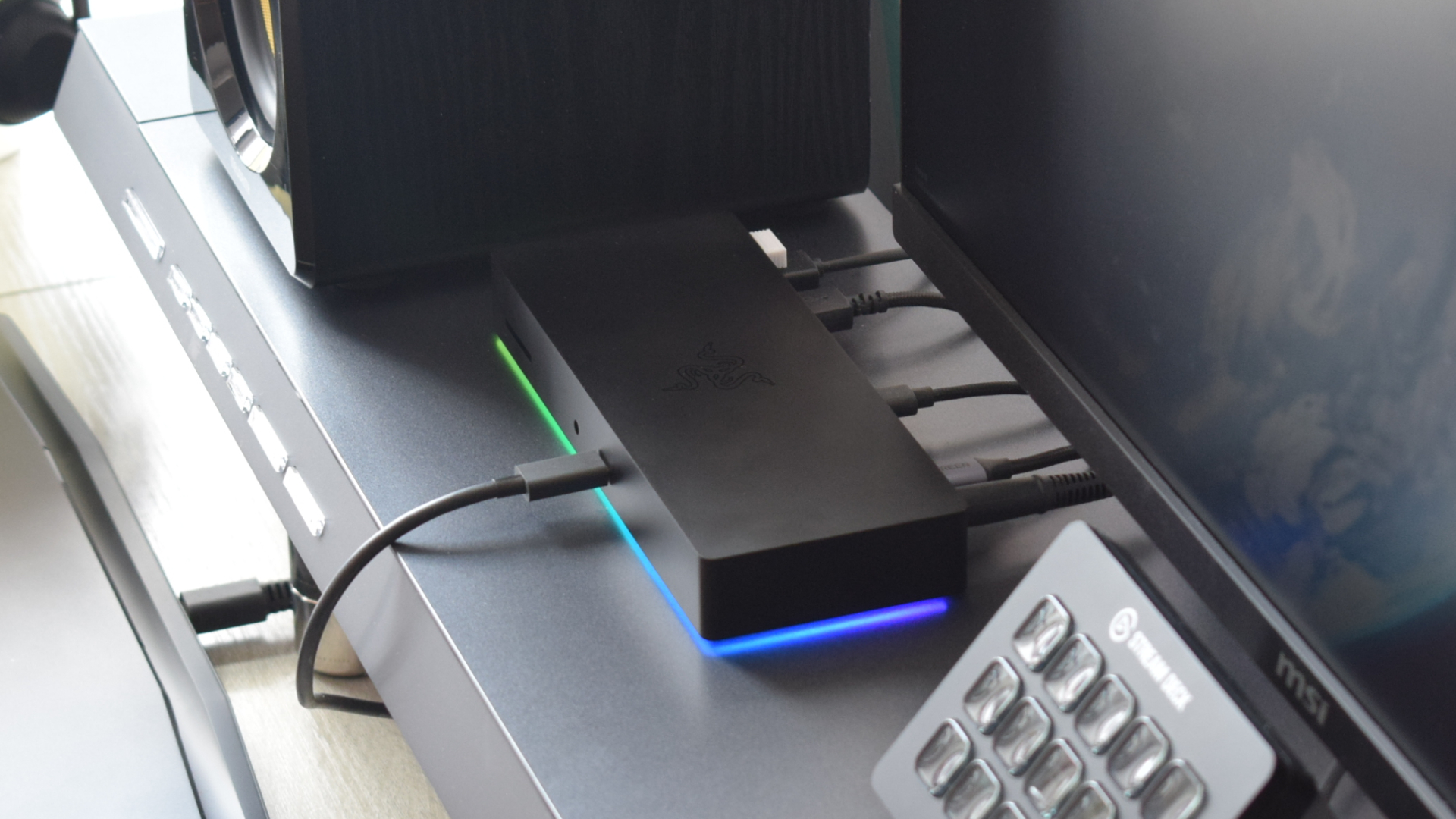 Side profile of the Razer Thunderbolt 4 Dock Chroma docking station with RGB lighting enabled in operation.