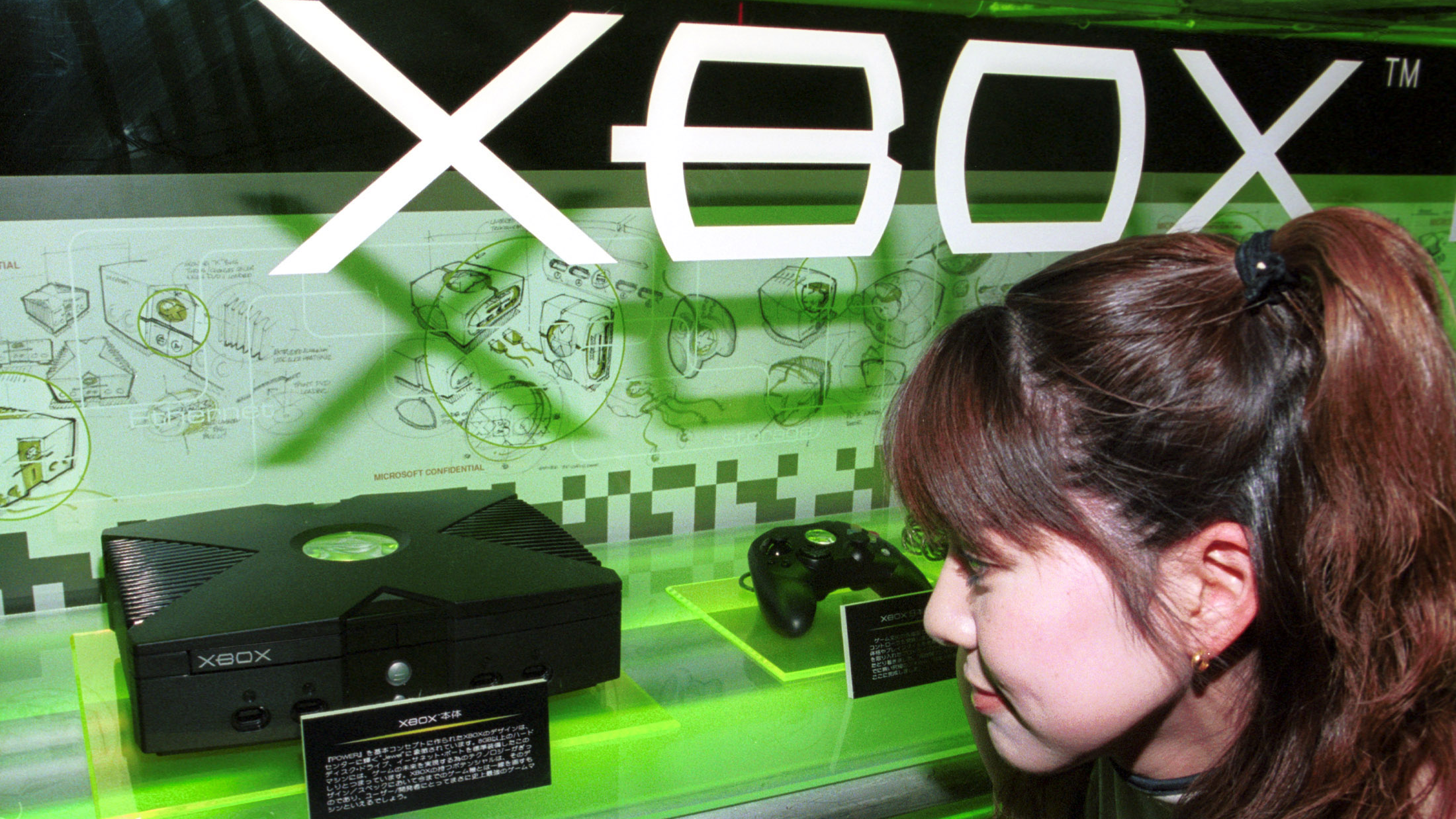 A woman looks at Microsoft's new Xbox game at the Tokyo Game Show April 1, 2001 in Tokyo, Japan. At the show, Bill Gates underscored Microsoft's commitment to the Japanese market and announced that more than 70 Japanese game companies, including Sega Corporation, have declared their support for Xbox. (Photo by Koichi Kamoshida/Newsmakers)